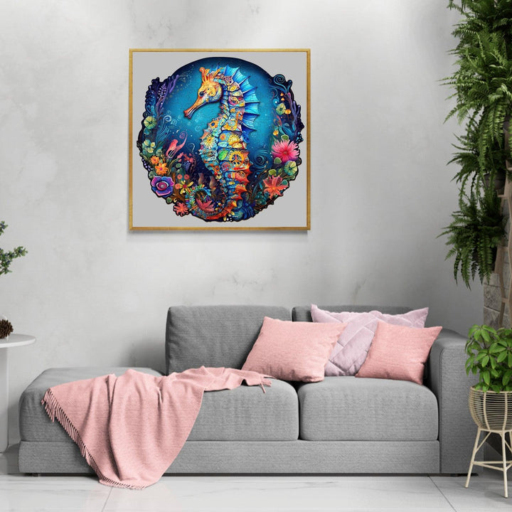 Colorful seahorse artwork displayed on a wall above a modern gray couch, showcasing vibrant marine life.