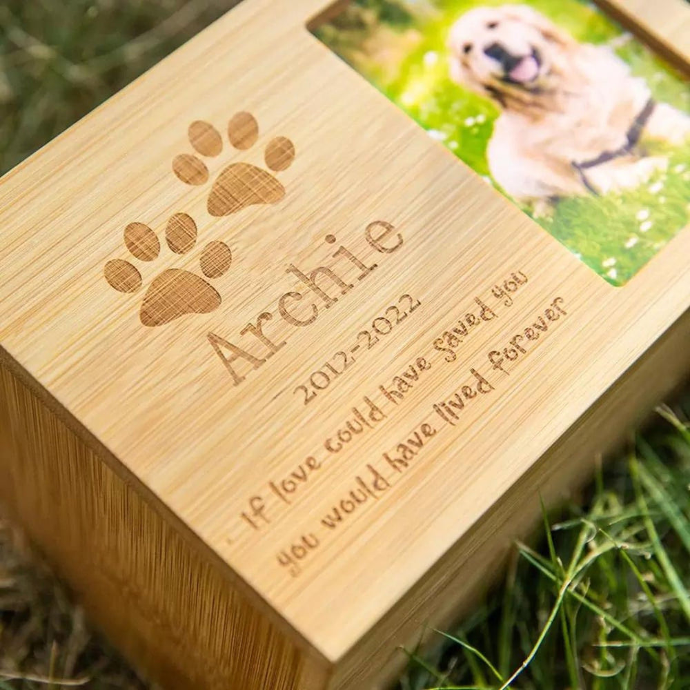 Personalized wooden pet urn with photo and engraved message honoring a beloved pet.