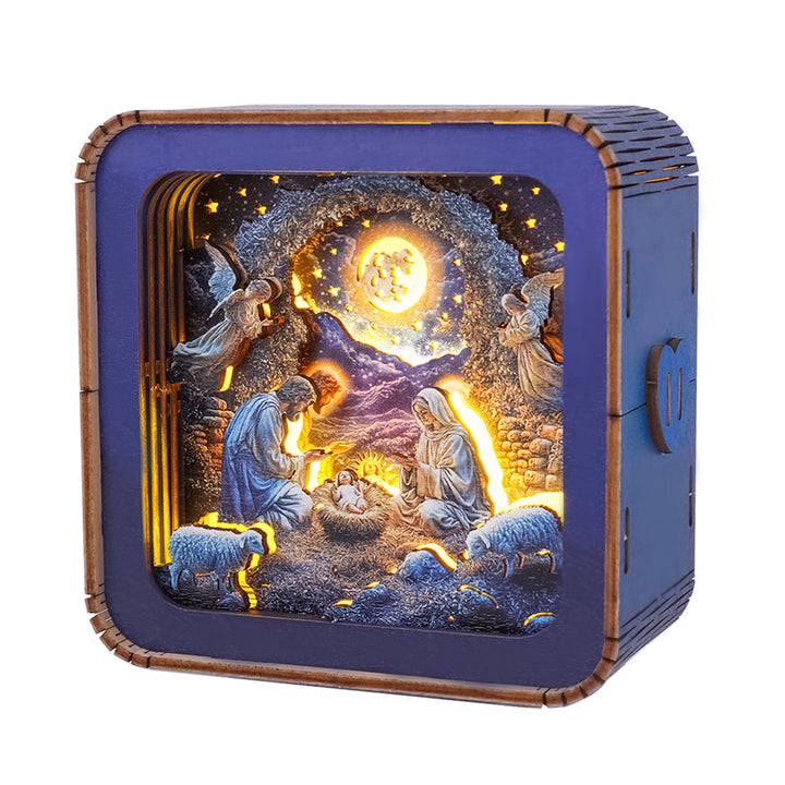 3D wooden puzzle night light featuring nativity scene with angels, Mary, Joseph, and baby Jesus illuminated against a starry background.