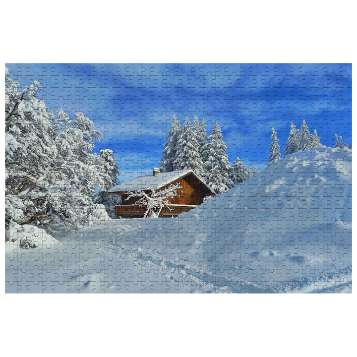 Snow Cabin jigsaw puzzle image depicting a cozy cabin surrounded by snowy trees and a clear blue sky.
