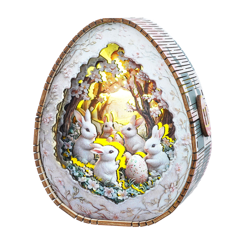 Easter egg wooden puzzle night light featuring rabbits in a floral scene, glowing softly in a whimsical design.