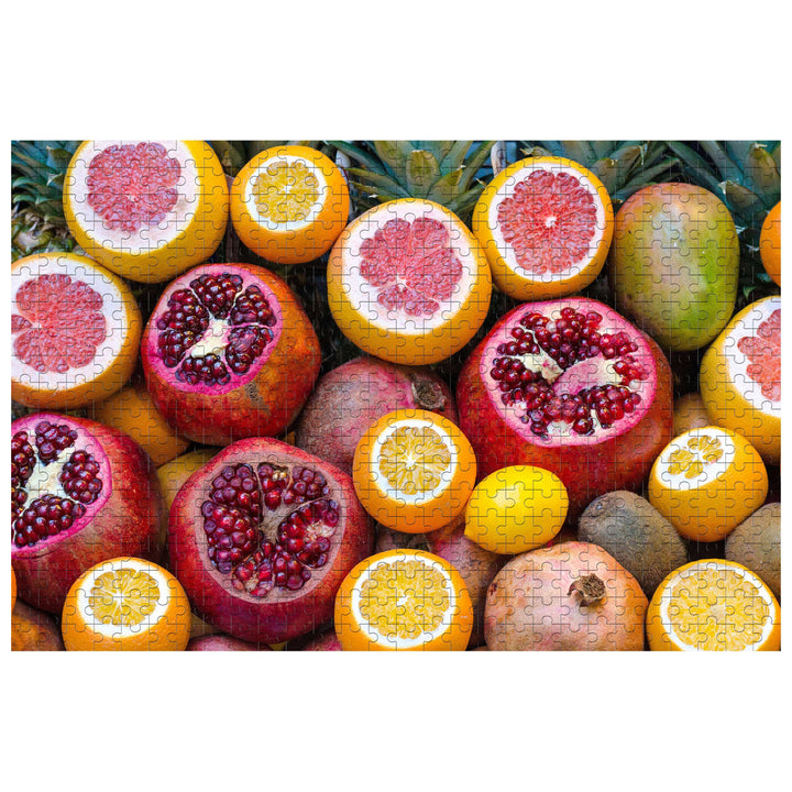 Colorful assortment of fruits puzzle featuring pomegranates and citrus fruits, perfect for mindful relaxation and focus.
