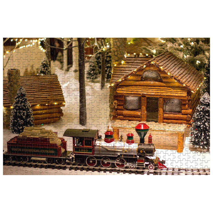 Christmas Train Paradise 500/1000 piece puzzle featuring a charming winter scene with a train and log cabin.