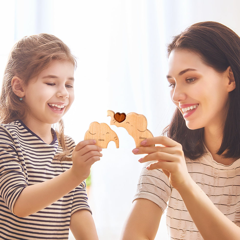 Mother and daughter joyfully holding a personalized wooden elephant family puzzle, celebrating love and togetherness.