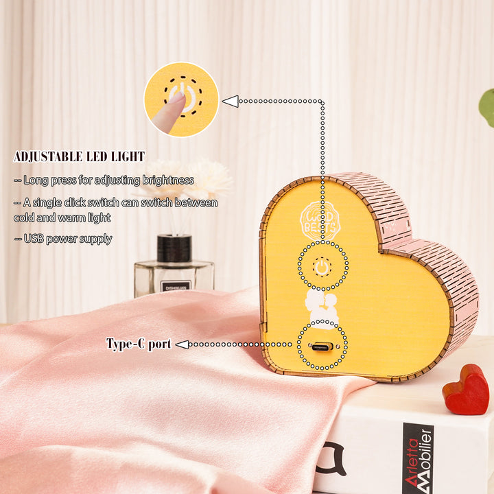 Adjustable LED heart-shaped night light with USB power supply and brightness control.