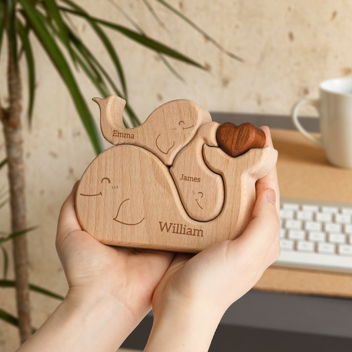 Customized wooden whale family name puzzle held by hands, showcasing names Emma, James, and William, perfect for family decor.