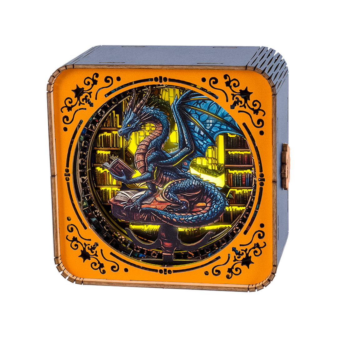 3D wooden puzzle night light featuring a blue dragon reading a book in a library setting.