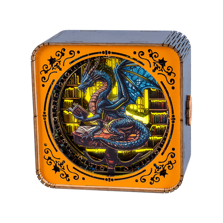 3D wooden puzzle night light featuring a blue dragon reading a book in a library setting.