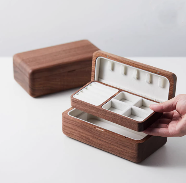 Elegant wooden double-layer jewelry box with ample storage for rings, necklaces, and earrings.