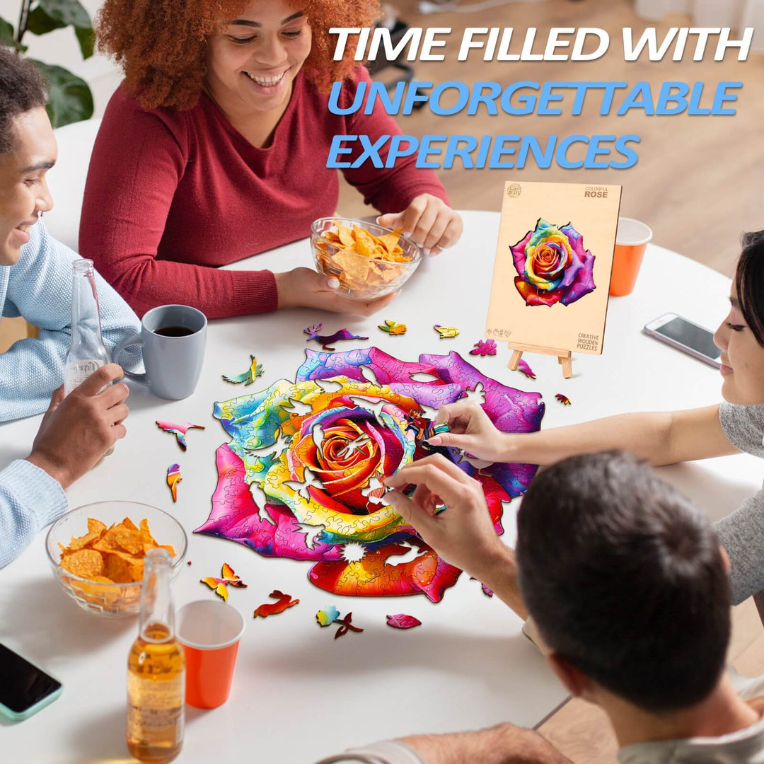 Group of friends enjoying the vibrant Colorful Rose wooden jigsaw puzzle with snacks in a cheerful atmosphere.