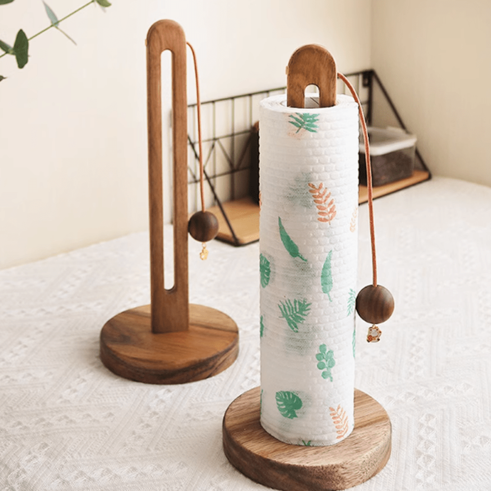 Wooden kitchen paper towel holder in natural acacia wood with decorative paper towels and anti-scatter rope.