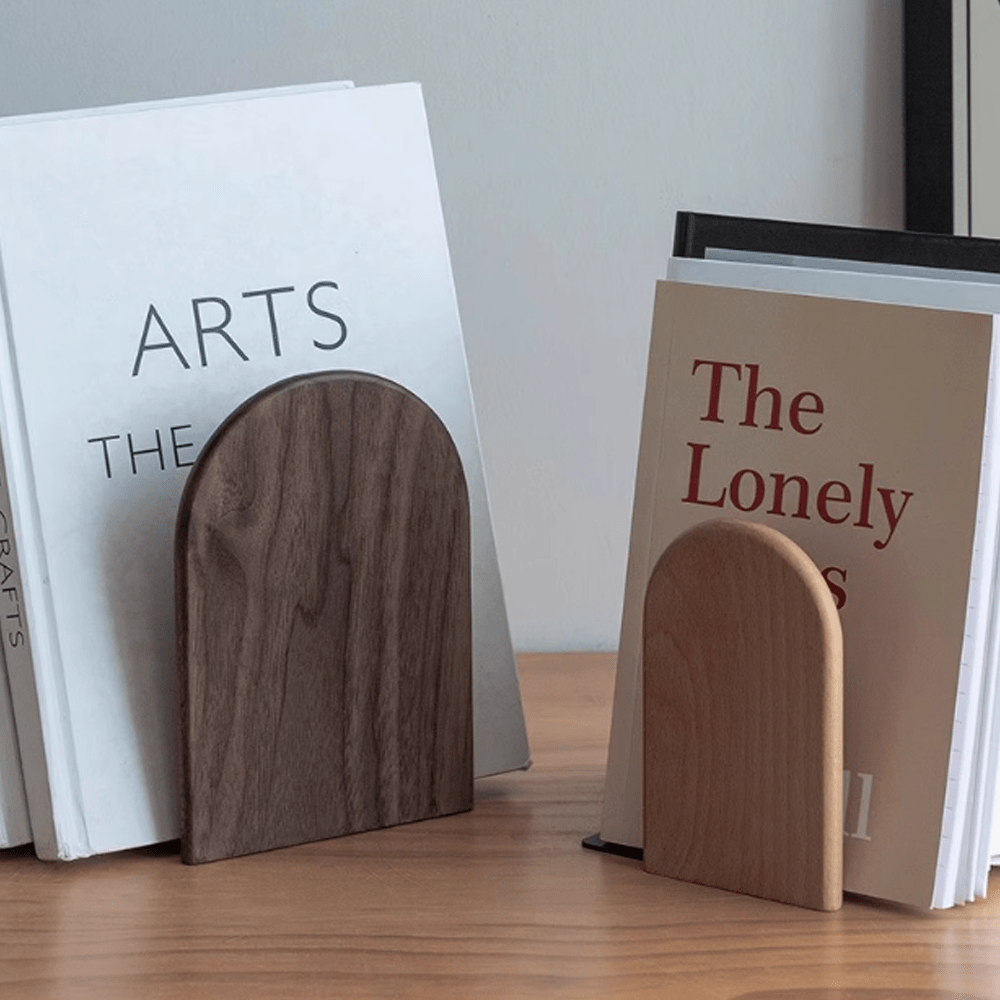 Elegant wooden bookends showcasing walnut and beech design, supporting books on a wooden surface.