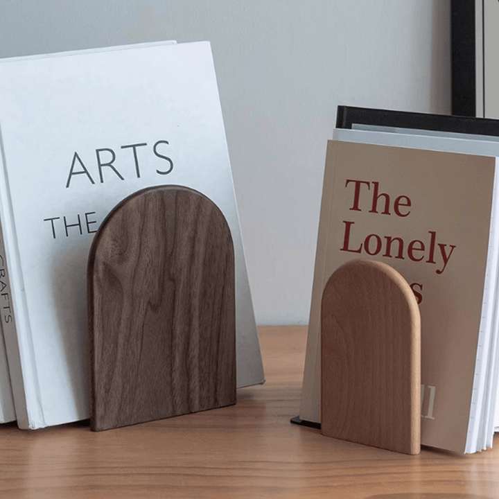 Elegant wooden bookends showcasing walnut and beech design, supporting books on a wooden surface.