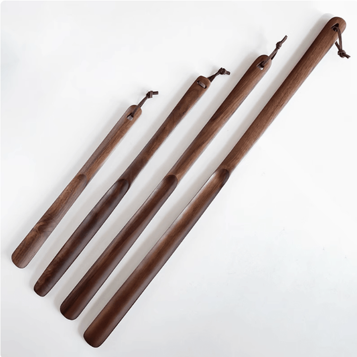Set of four walnut shoe horns, crafted from natural walnut wood, showcasing elegant design and ergonomic comfort.