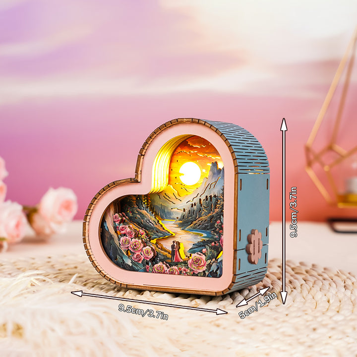 Heart-shaped 3D wooden puzzle night light, featuring a romantic scene with roses and a couple by a river.