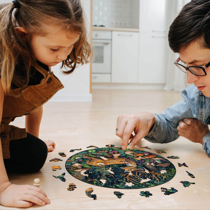 Father and daughter solving the SEEK AND FIND FROGS wooden jigsaw puzzle together for fun and focus.