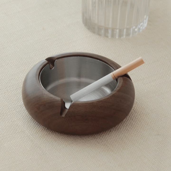 Round wooden ashtray with stainless steel liner, featuring a delicate walnut texture and elegant design.