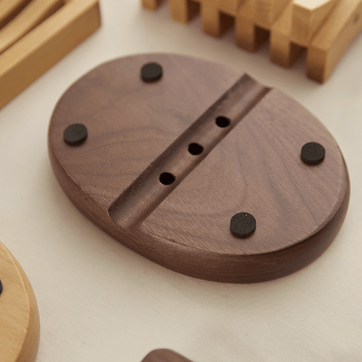 Log style soap box made from walnut wood with a sleek design and black rubber feet for stability.