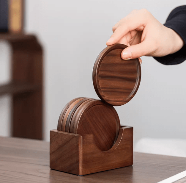 Minimalist wooden coasters in a holder on a dining table, showcasing warm walnut tones and elegant design.