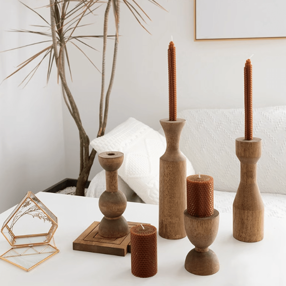 American retro wooden candle holders with warm tones and textures on a stylish coffee table.