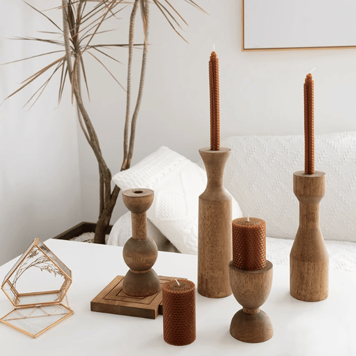 American retro wooden candle holders with warm tones and textures on a stylish coffee table.