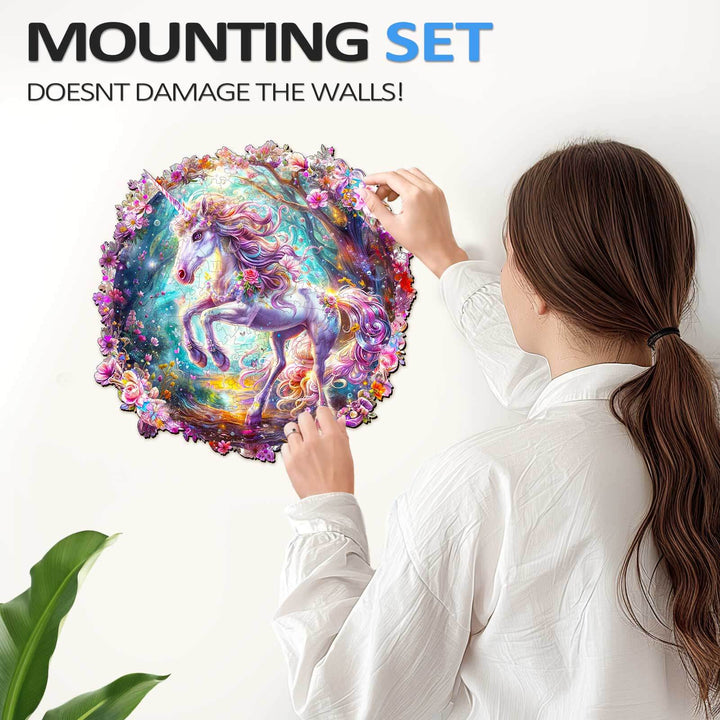 A woman attaching a colorful unicorn puzzle to a wall using a mounting set that doesn't damage the walls.