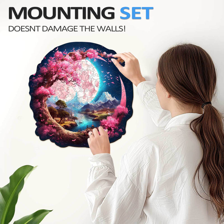 Woman assembling a beautiful moon wooden jigsaw puzzle featuring a serene garden landscape.