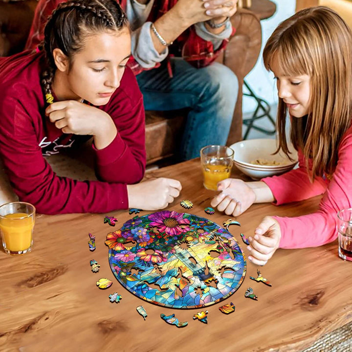 Two girls enjoying a Stained Glass Lighthouse jigsaw puzzle on a table, enhancing focus and cognitive skills.