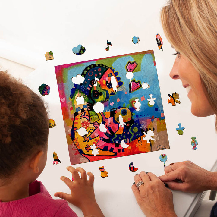 Mother and child engaging with colorful puzzle art by Shirin Moarefi, exploring creativity together.