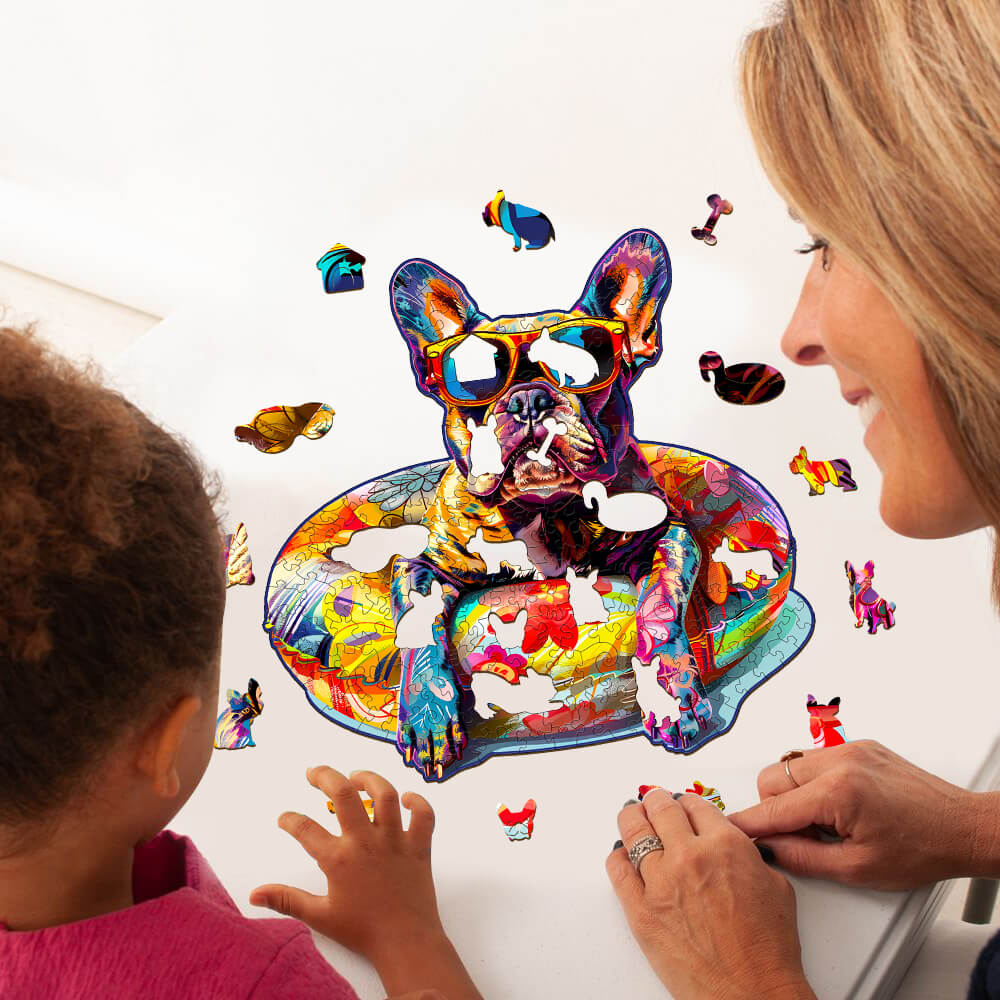 Colorful French Bulldog wooden jigsaw puzzle being assembled with a child by a parent, promoting mindfulness and fun.