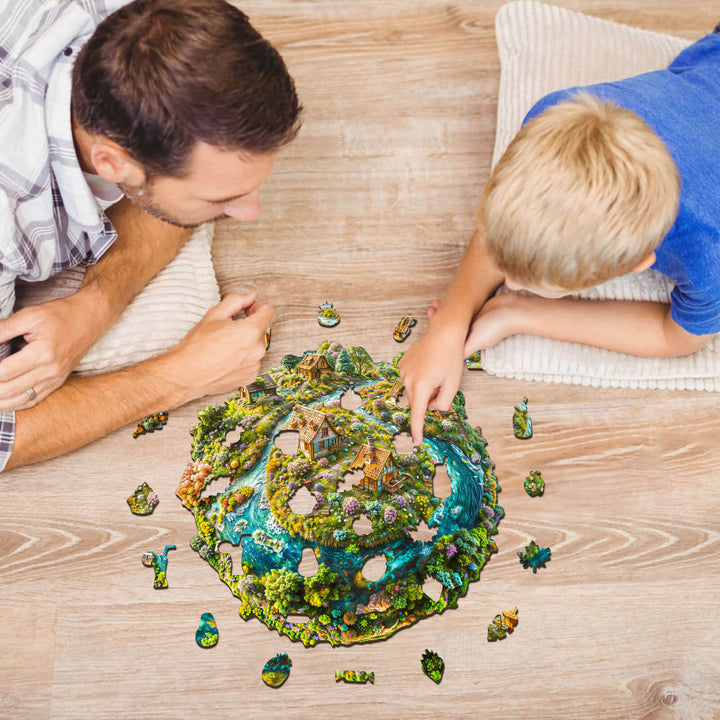 Father and son enjoying the Sustainable Earth wooden jigsaw puzzle together on a cozy floor.