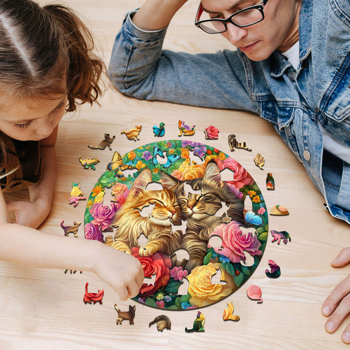 A child and adult enjoy assembling the Cats in Love-2 wooden jigsaw puzzle, featuring playful cats and vibrant roses.