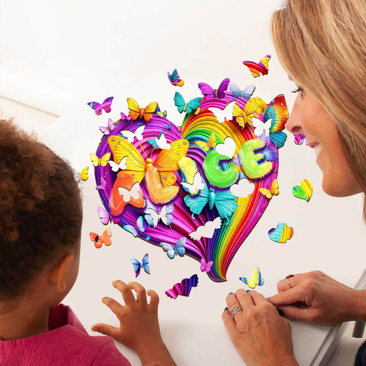 A child and adult engaging with a colorful heart-shaped puzzle featuring butterflies and the name 'Alice' in vibrant letters.