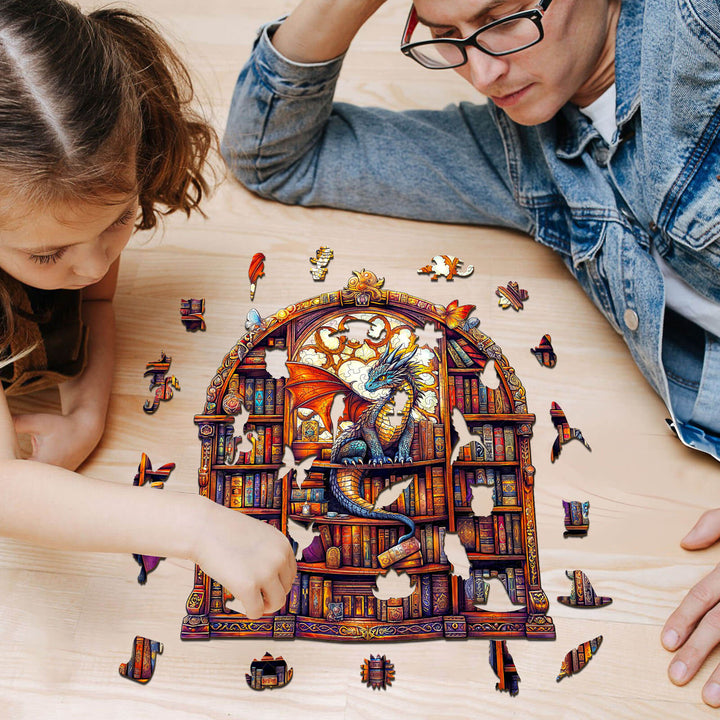A father and daughter engaged in solving the SEEK AND FIND QUILLS wooden jigsaw puzzle featuring a dragon in a library.