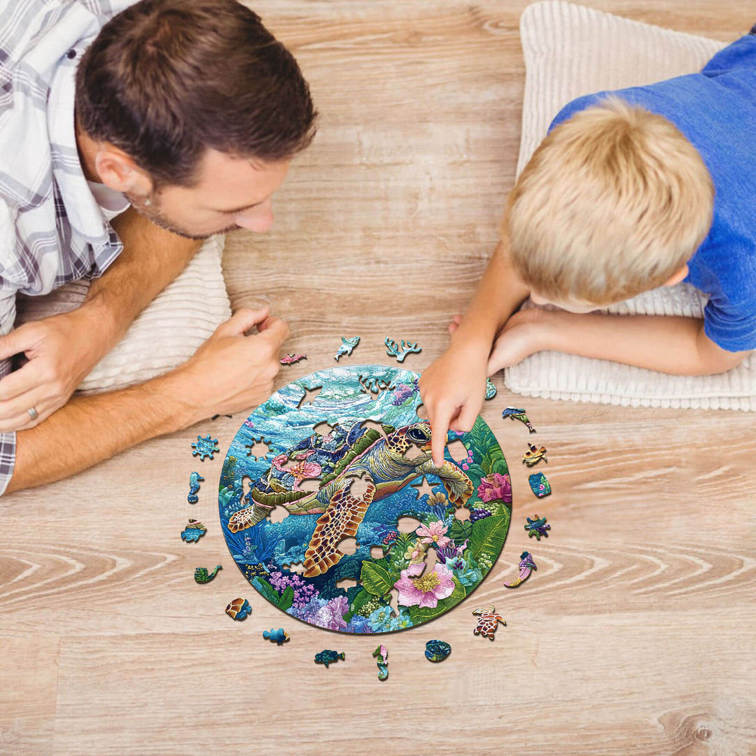 A father and son working together on an embroidered turtle wooden jigsaw puzzle surrounded by colorful pieces.