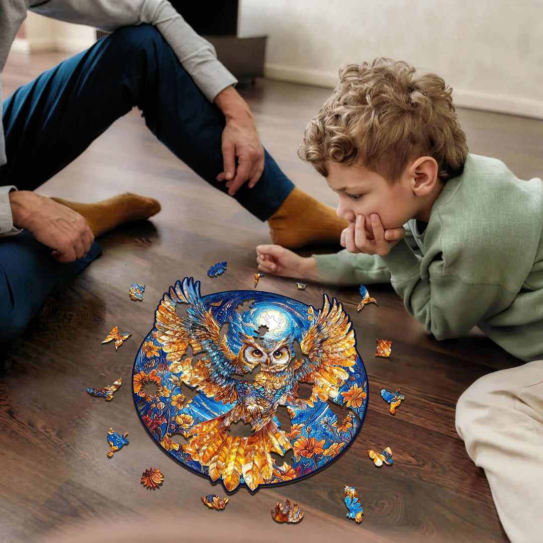 Child and adult assembling a Golden Owl wooden jigsaw puzzle together on the floor, enhancing focus and cognitive skills.
