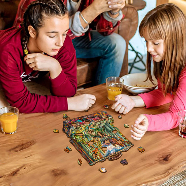 Two girls assembling the Desert Odyssey-1 Wooden Jigsaw Puzzle on a table with drinks nearby.