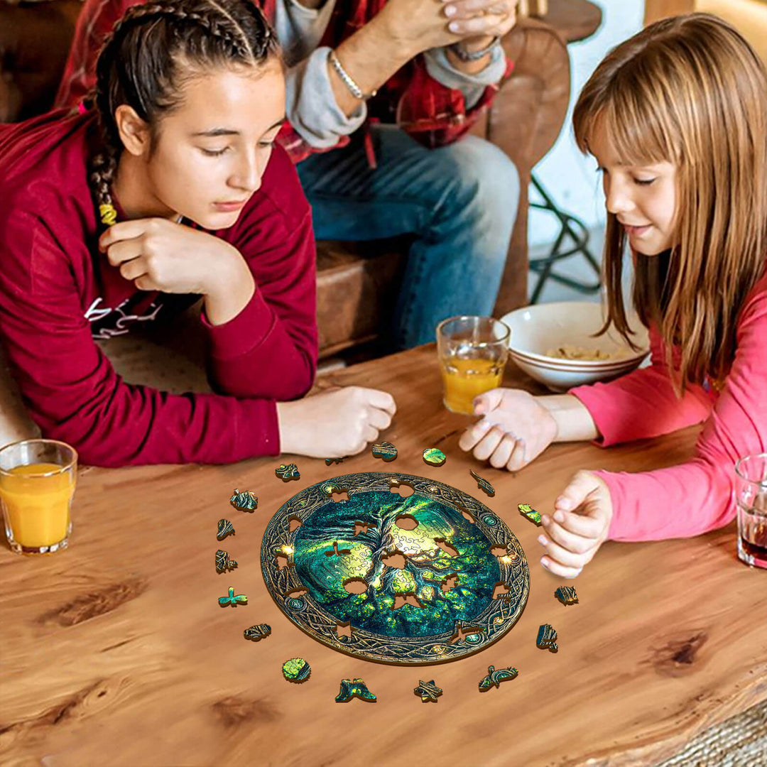 Two girls enjoying the Eternal Tree wooden jigsaw puzzle at home, focusing on puzzle pieces around a round table.