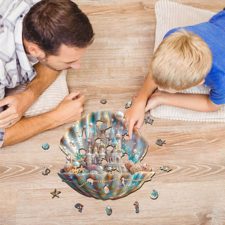 Father and son working on the Pearlspire Citadel-1 wooden jigsaw puzzle on a wooden floor.