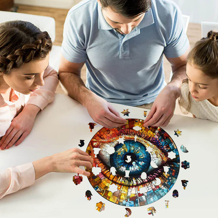 Family enjoying a fun 3D Stained Glass Eyes wooden jigsaw puzzle at a table, emphasizing focus and teamwork.