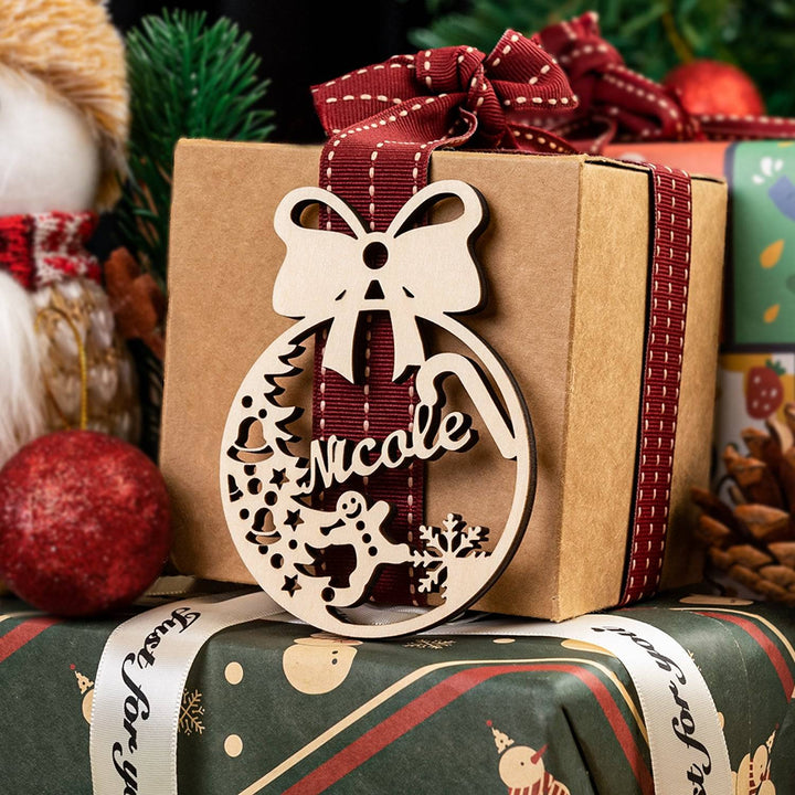 Personalized wooden ornament with bow, featuring the name Nicole, hanging on a beautifully wrapped gift.