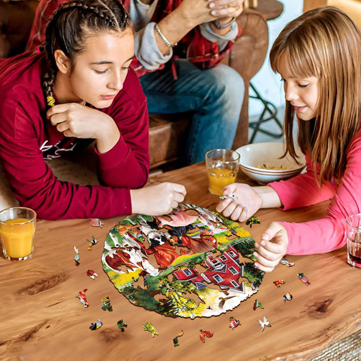 Two girls solving a Farm Animals wooden jigsaw puzzle together at a wooden table with drinks and snacks.