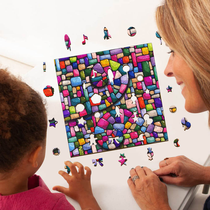 A child and an adult collaboratively working on a colorful mosaic puzzle, surrounded by vibrant puzzle pieces.