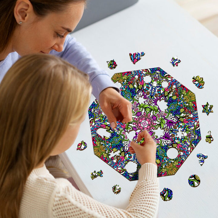 A mother and daughter enjoy assembling a colorful doodle art puzzle by artist Lori Anne McKague, showcasing creativity together.