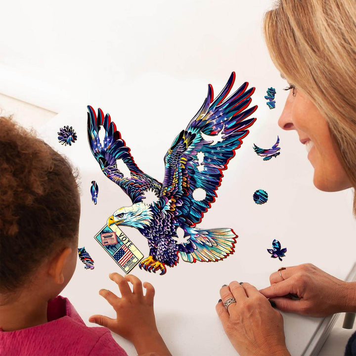 A young child and adult solving the Bald Eagle's Vote jigsaw puzzle, featuring an eagle carrying a ballot.