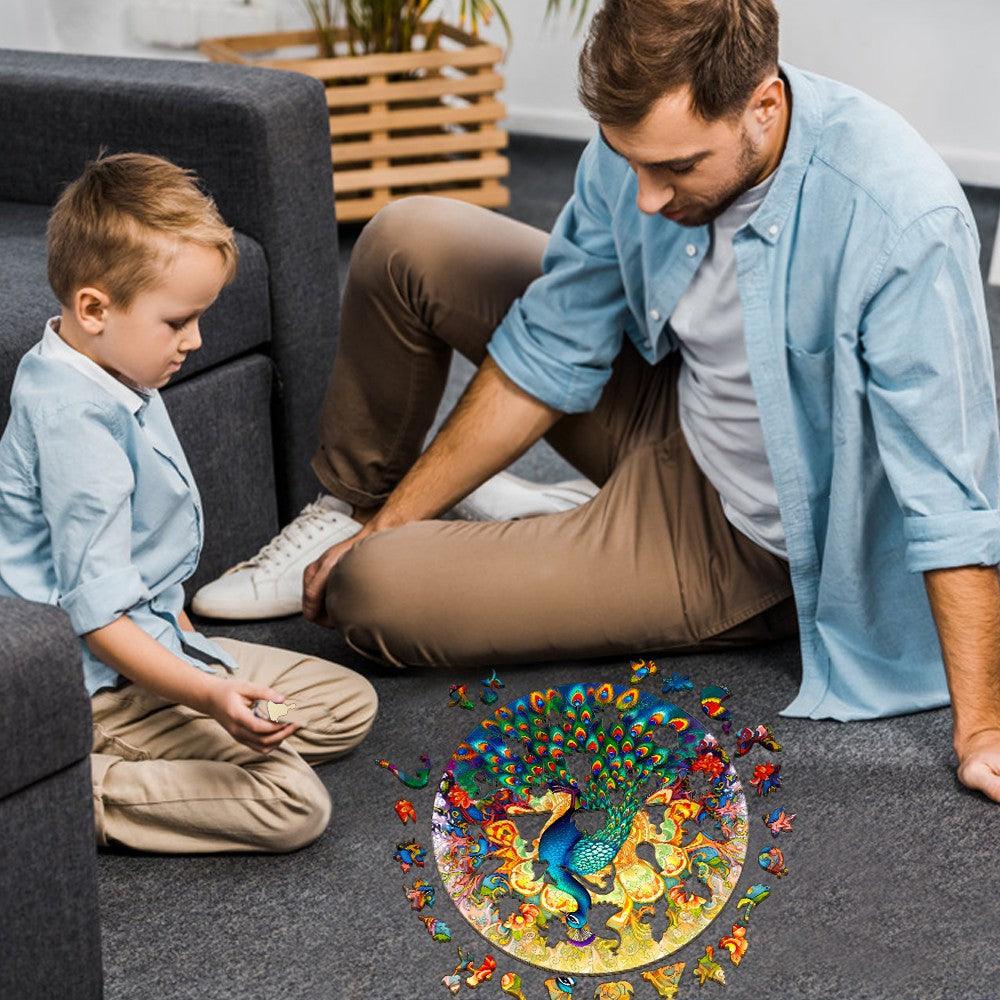 Father and son enjoy assembling a colorful Mandala Peacock wooden jigsaw puzzle together on a living room floor.