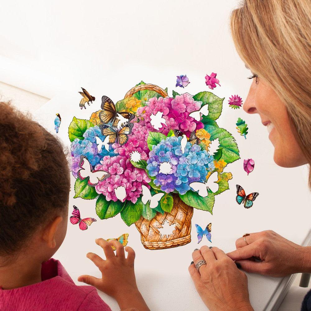 Mother and child assembling a colorful Flower Basket & Butterfly wooden jigsaw puzzle with vibrant flowers and butterflies.