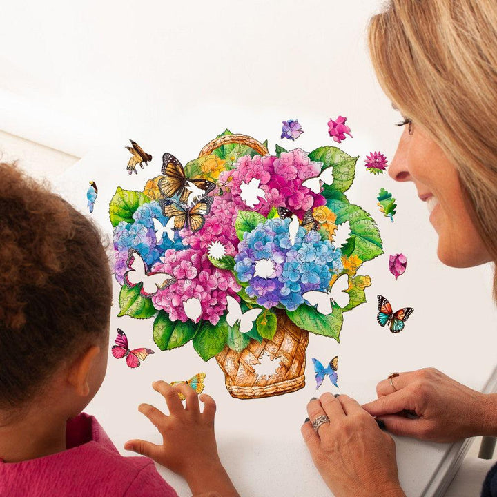 Mother and child assembling a colorful Flower Basket & Butterfly wooden jigsaw puzzle with vibrant flowers and butterflies.