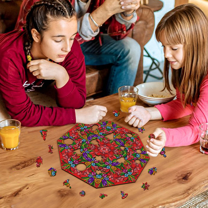 Two girls enjoying a doodle art game featuring vibrant floral patterns, surrounded by drinks and snacks.