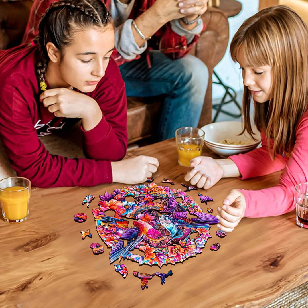 Two girls enjoying the Flower Hummingbird wooden jigsaw puzzle on a wooden table, enhancing focus and critical thinking.